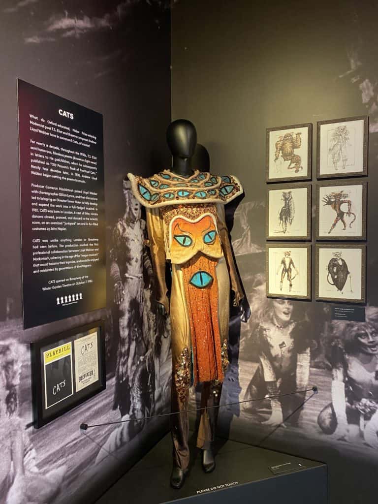 Costume from CATS musical on display with sketches on display board.