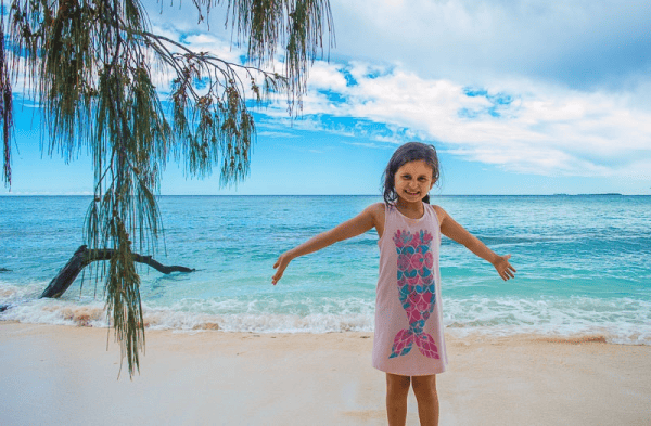 Young girl standing on beach, Lady Musgrave Island, Bundaberg, Queensland, Australia.