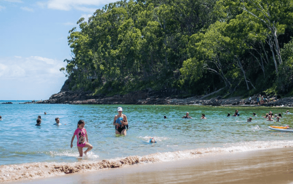 People in water at beach - Noosa National park on the Sunshine Coast in Queensland, Australia.