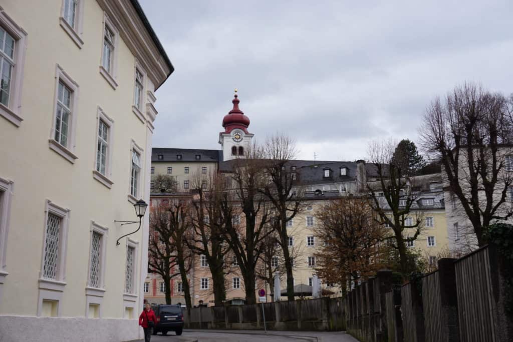 Salzburg, Austraia buildings and treets with red dome of Nonnberg Abbey in background.