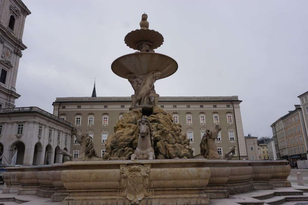 Large fountain with horses at base in Residenz Square, Salzburg, Austria.