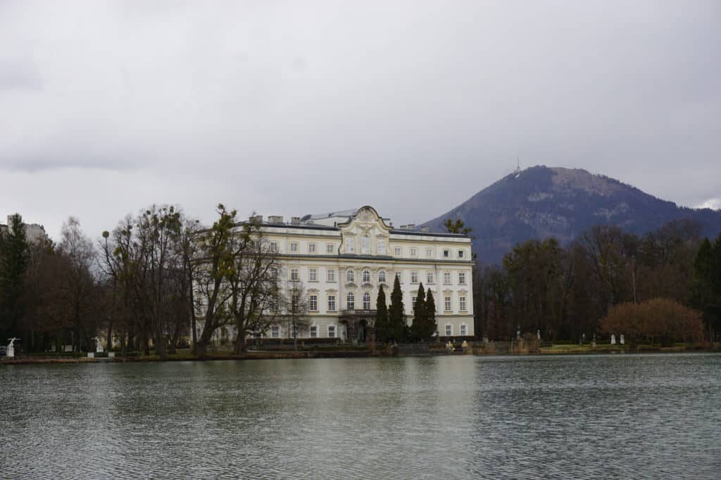 Exterior Schloss Leopoldskron viewed from across a body of water in Salzburg, Austria.