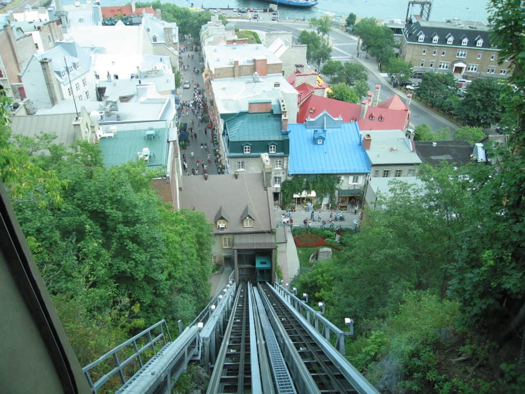 View down the rails of the funicular to the buildings of lower town Quebec City.