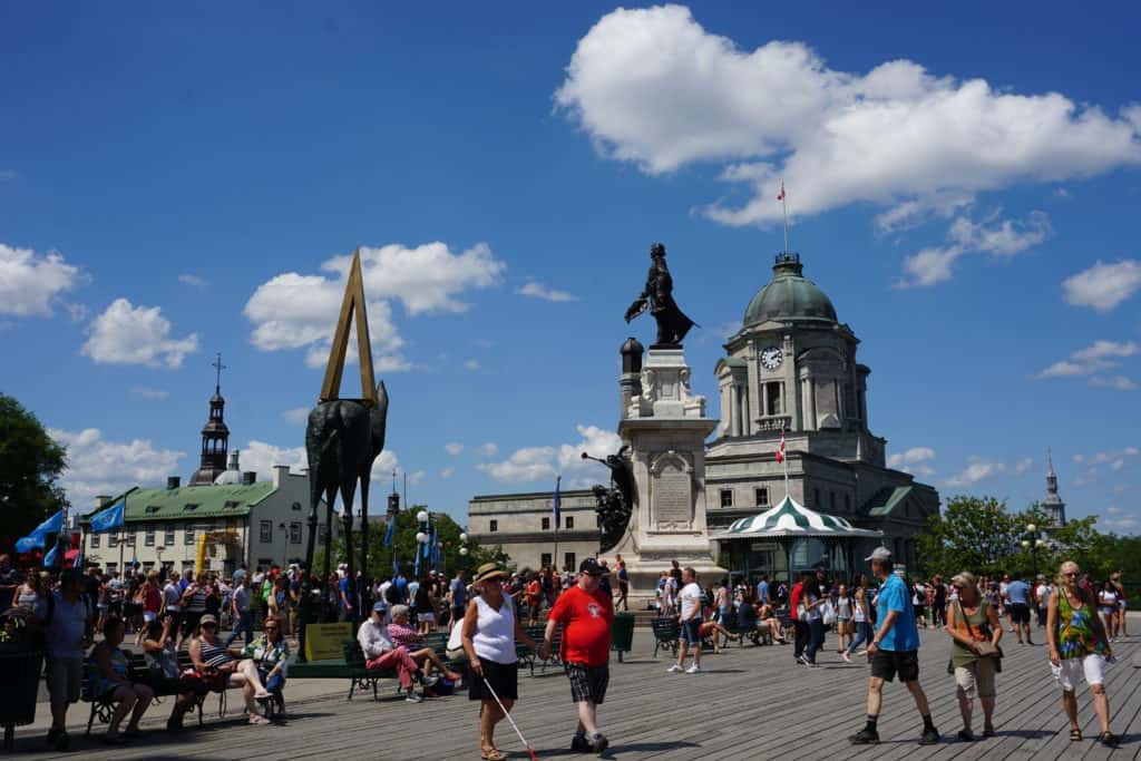 Crowd of people on boardwalk by Chateau Frontenac in Quebec City.