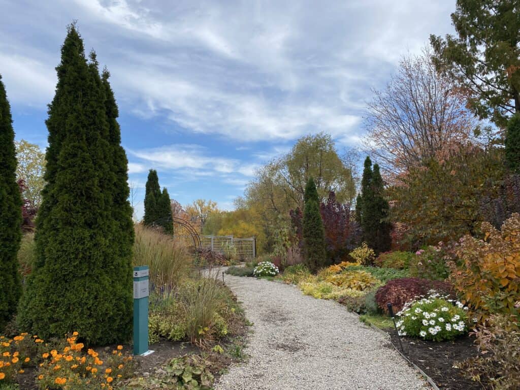 Walking path through fall gardens at The Riverwood Conservancy in Mississauga.