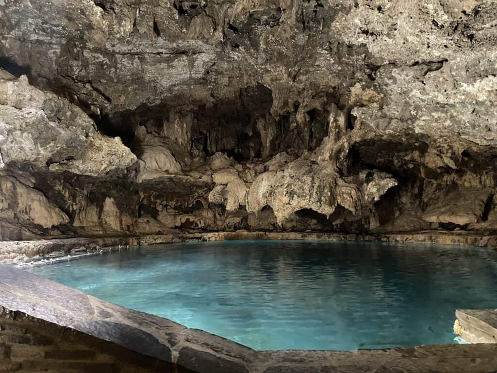 Blue green coloured water in cave at Cave and Basin National Historic Site.