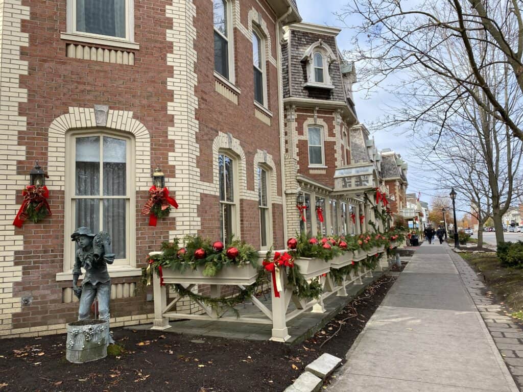 Queen Street in Niagara-on-the-Lake with festive red bows and greenery on the exterior of the Prince of Wales hotel.