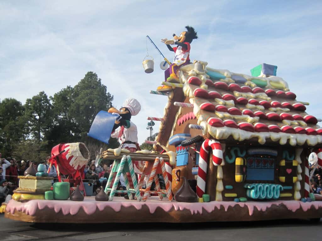 Disneyland holiday parade float with gingerbread house, Goofy and Max.