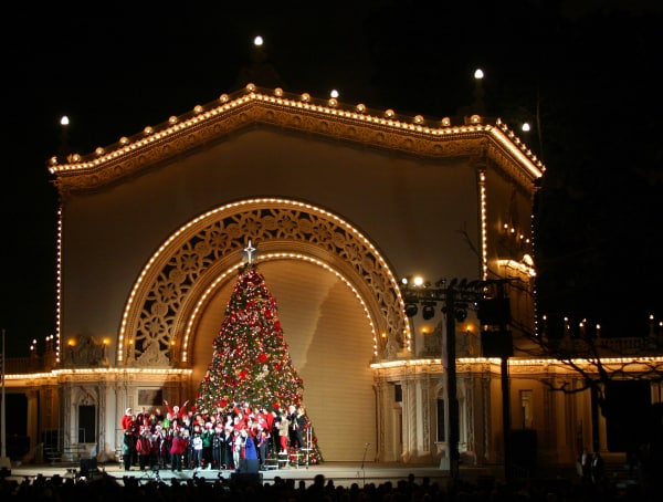 Choir singing in front of Christmas tree on bandstand at Balboa Park, San Diego during December Nights.