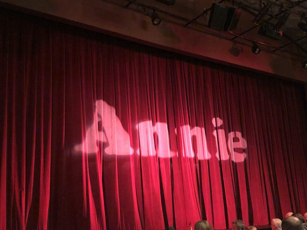 The word Annie on red theatre curtain at Drayton Festival Theatre.