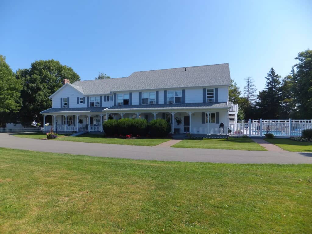 Kindred Spirits Country Inn - white with blue/grey trim - swimming pool to the right of inn.