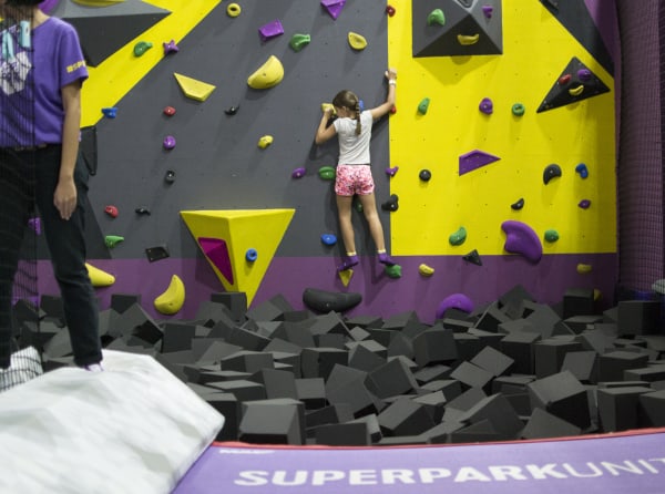 Young girl on climbing wall at Superpark in Kuala Lumpur.