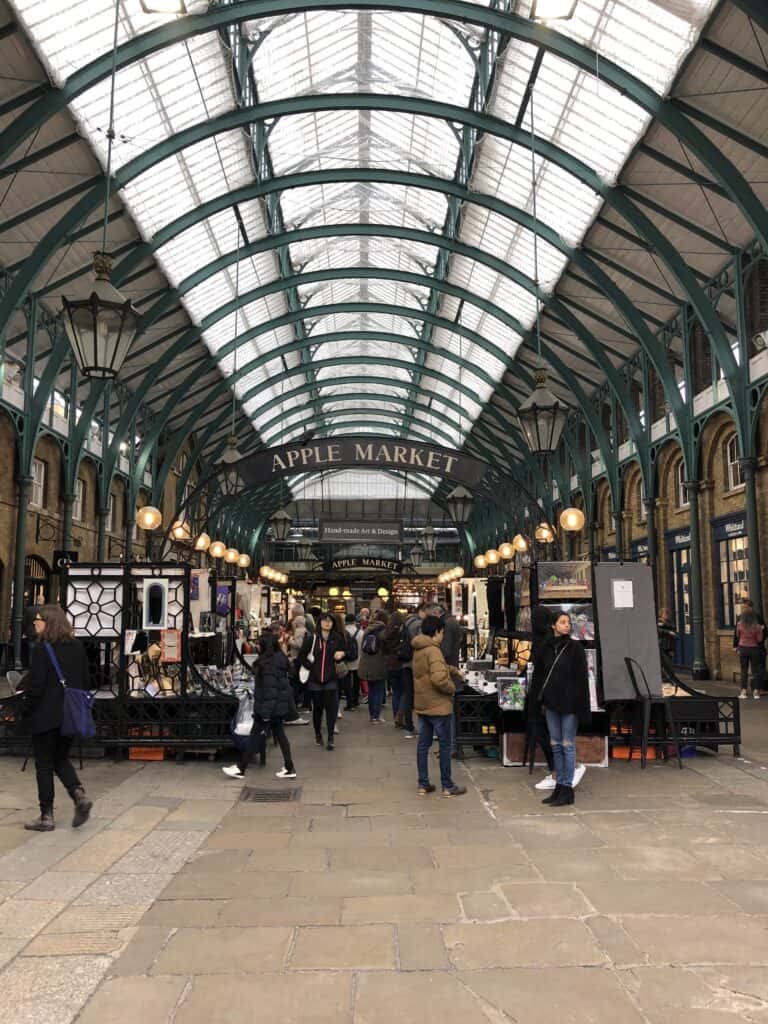 People wandering stalls in Covent Garden, London.