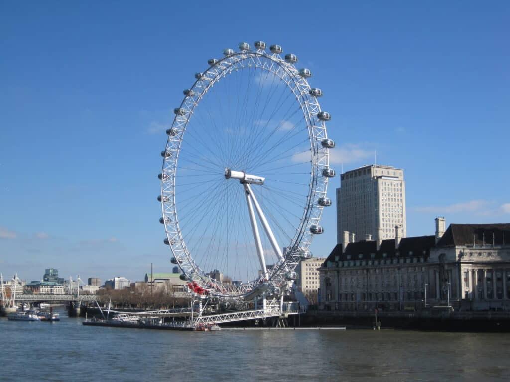 The London Eye set against bright blue sky.