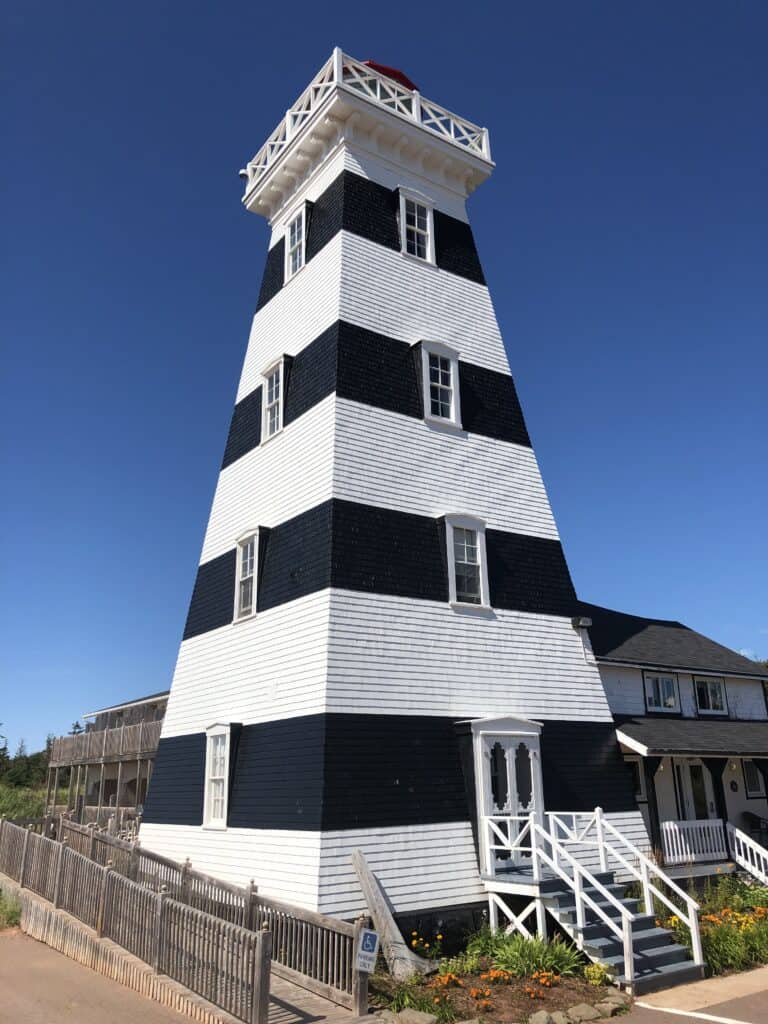 West Point Lighthouse Inn with bright blue cloudless sky.
