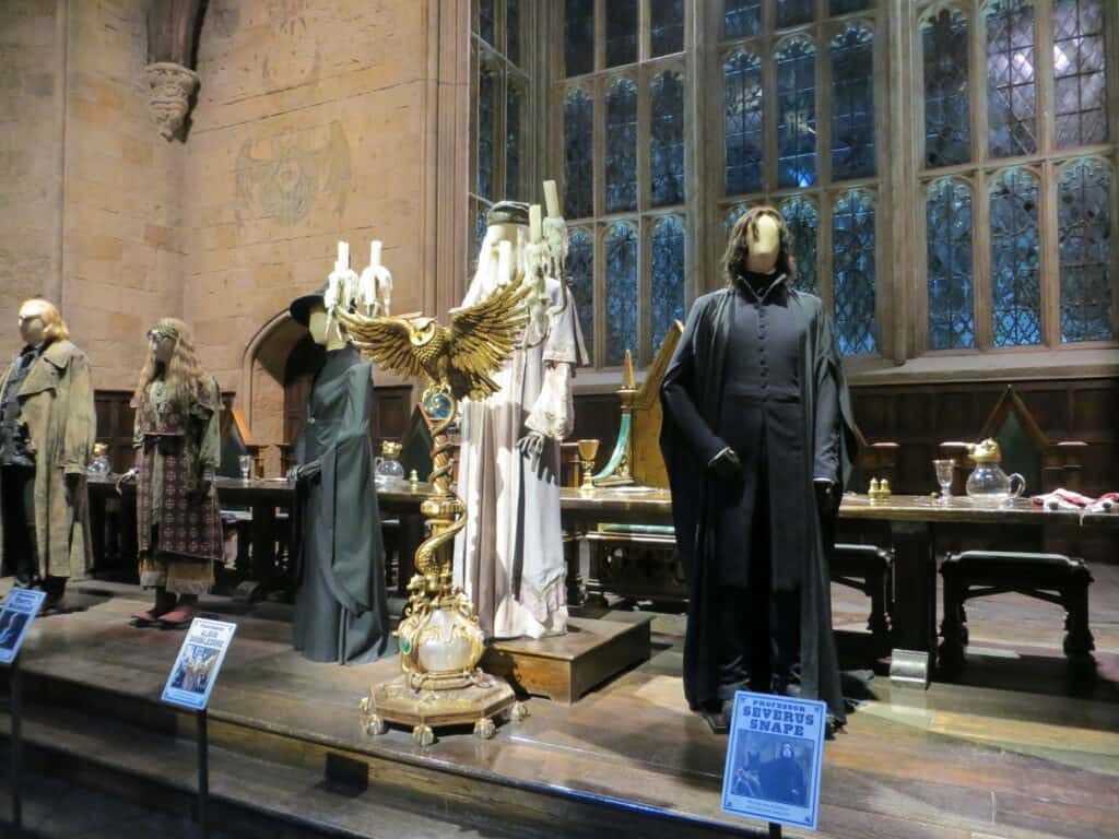 The Hogwarts Great Hall including costumes on mannequins at Warner Bros. Studio Tour London.