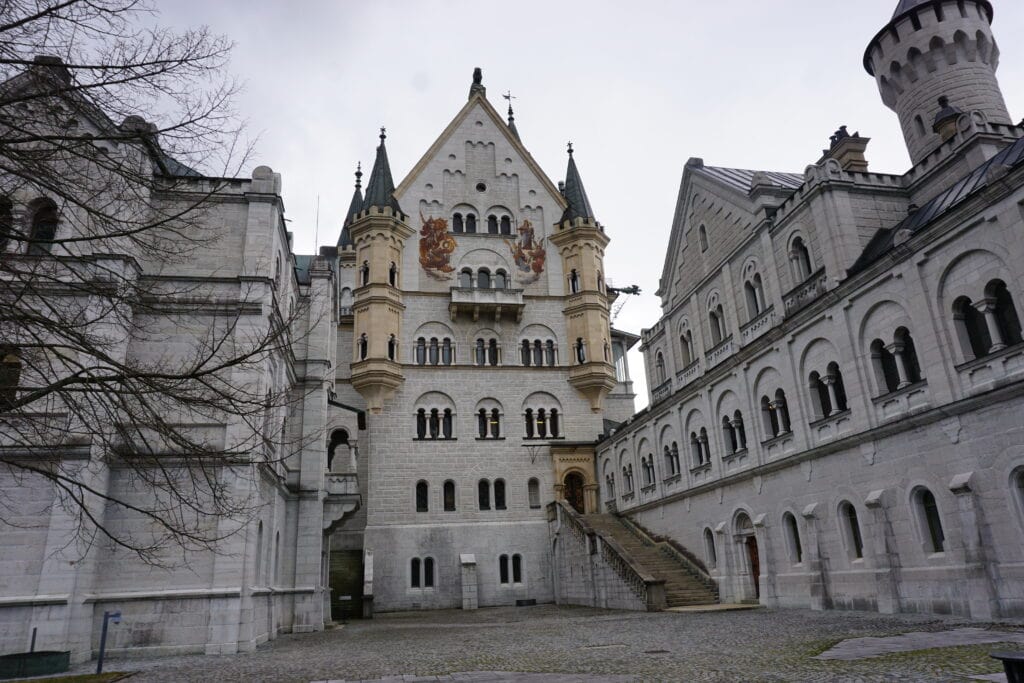 Entrance to Neuschwanstein Castle with gray skies.