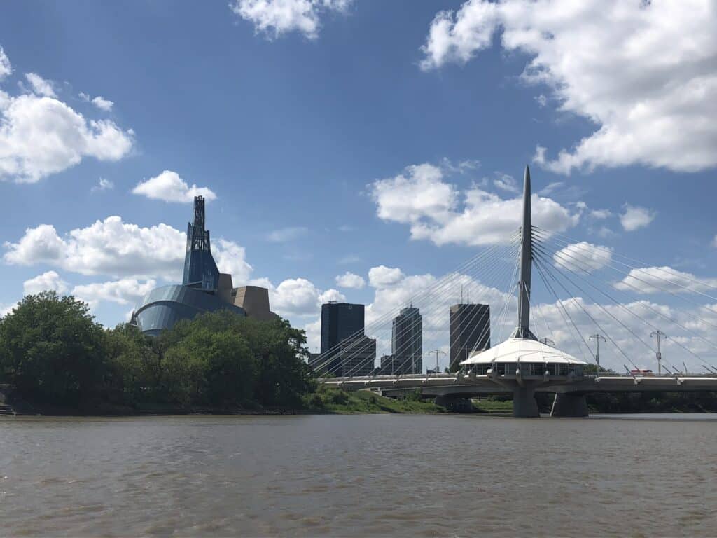 View across river of the Canadian Museum for Human Rights and the Esplanade Riel in Winnipeg, Manitoba.
