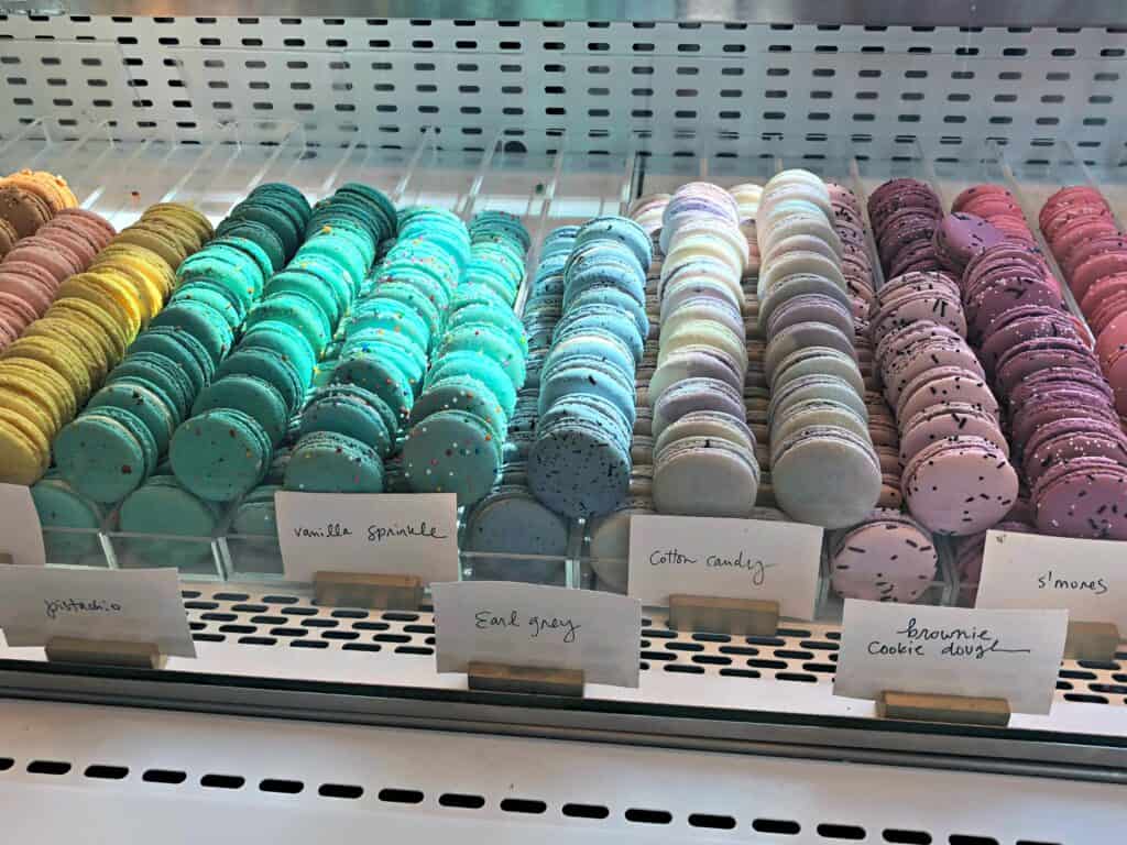 Rows of coloured macarons on display at The Forks Market in Winnipeg, Manitoba.