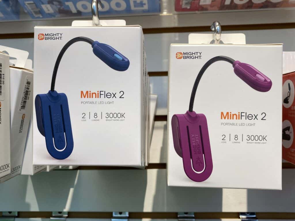Boxes of blue and purple MiniFlex 2 Book Lights on display at Indigo store.
