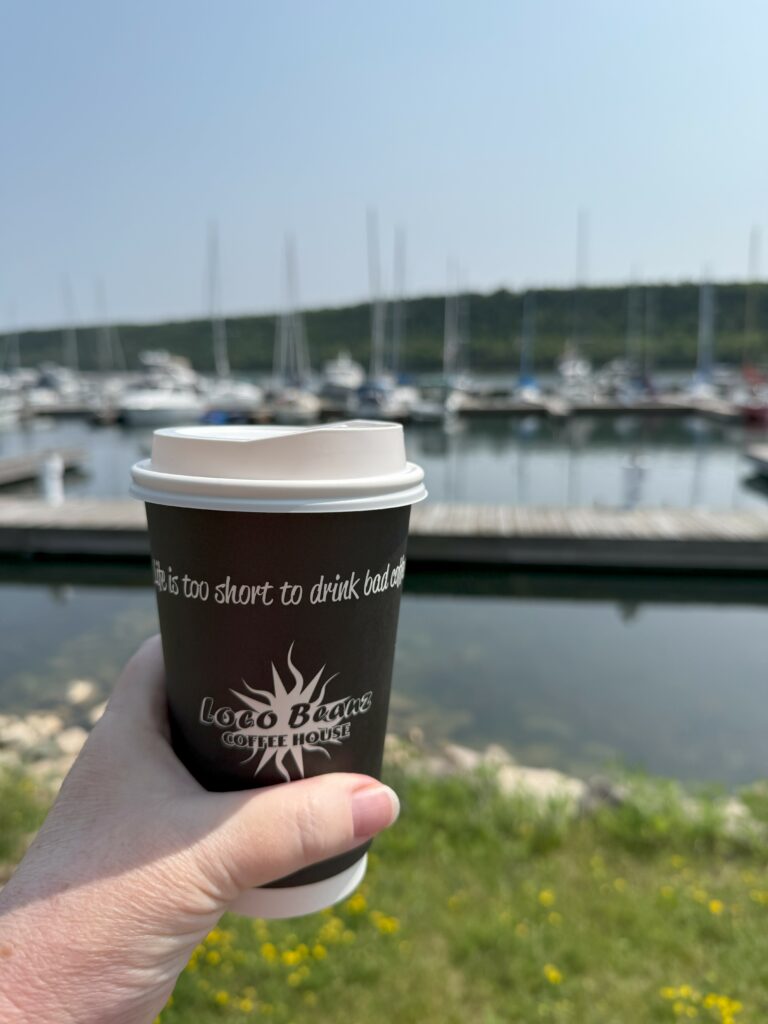 Loco Beanz take-out cup with Gore Bay Marina in the background - Manitoulin Island.