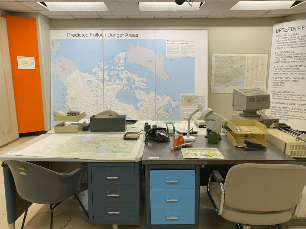 Room set up at Diefenbunker: Canada's Cold War Museum with large map on wall of Predicted Fallout Danger Areas.