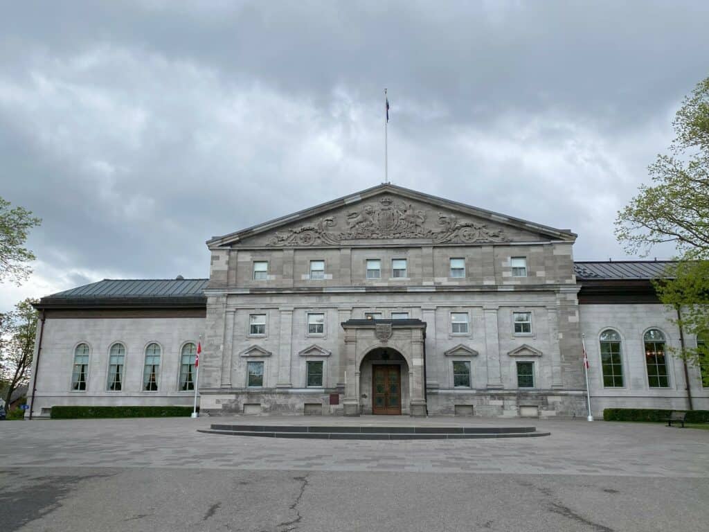 Grey stone exterior of Rideau Hall in Ottawa on an overcast day.