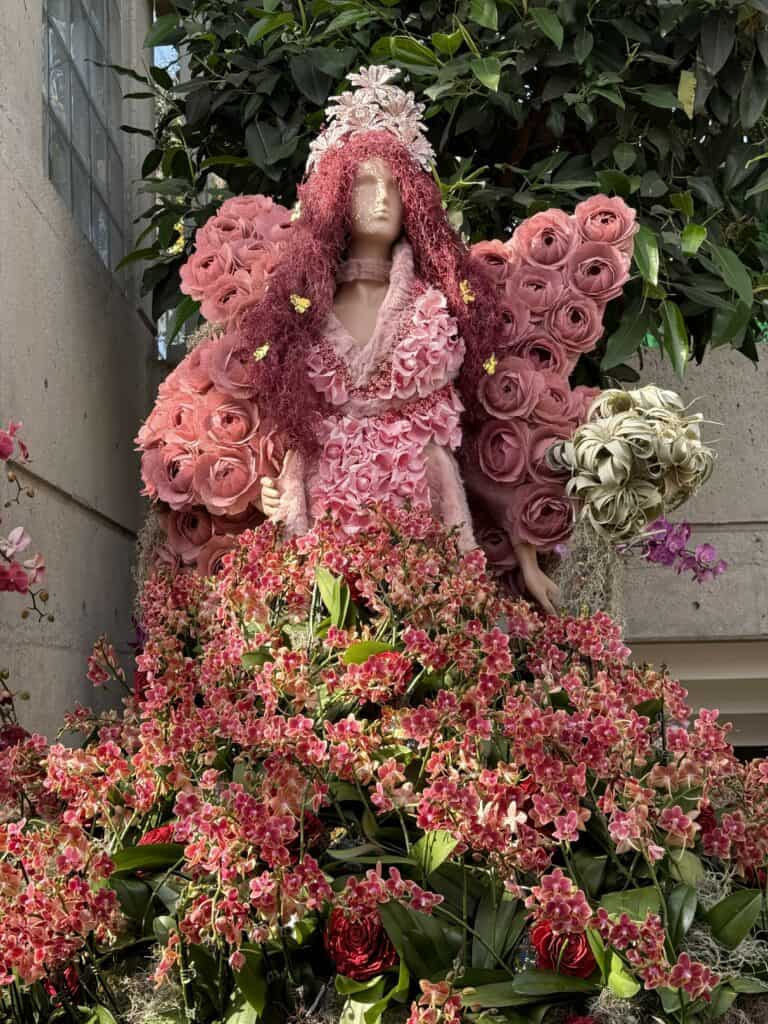 female mannequin with gown made of pink flowers