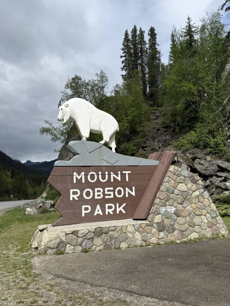 Mount Robson Park entrance sign - mountain goat on peak above words "Mount Robson Park".