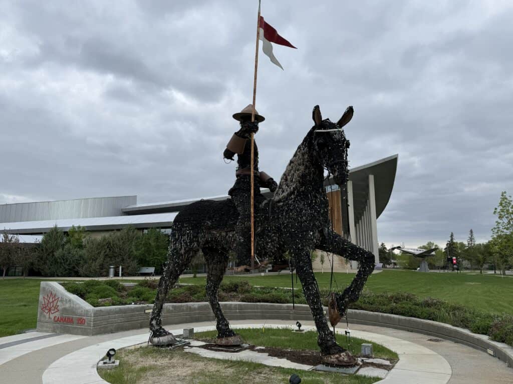 horse and RCMP rider structure made from horticultural materials outside the RCMP Heritage Centre on an overcast day.