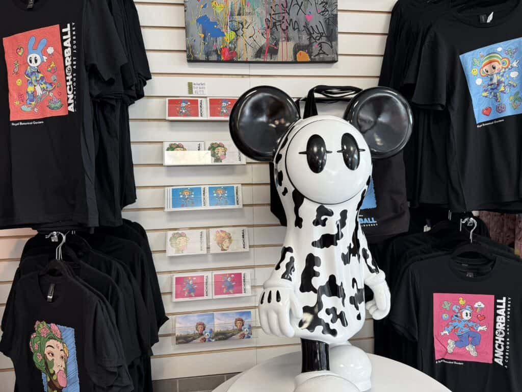 black and white anchorball figurine on display with shirts and postcards in the rbg shop.