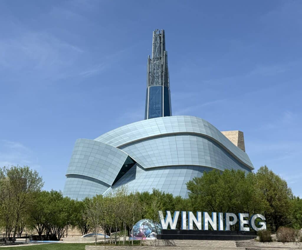 exterior of the canadian musuem for human rights with winnipeg sign in front.