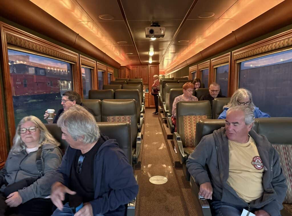 passengers seated in the seating area of the stone gardner car on the agaway canyon tour train before departure.